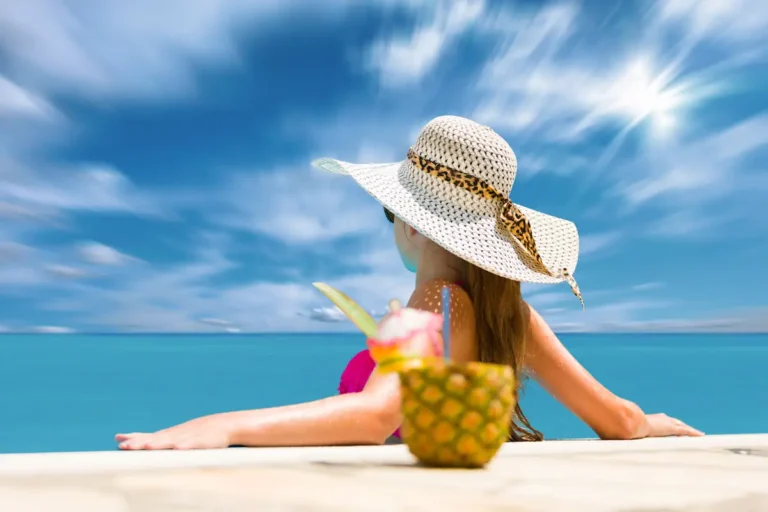Une femme en train de se détendre à côté d'un cocktail de fruit